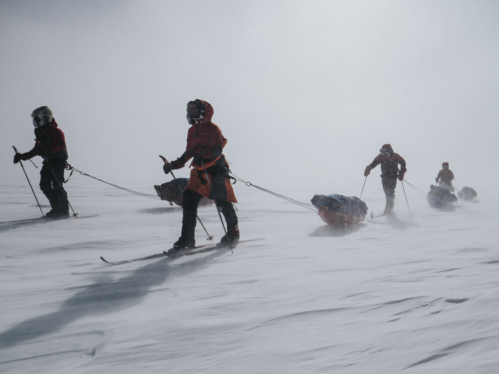 Inspiring Explorers Expedition&trade; team crossing the ice cap in high winds (001)