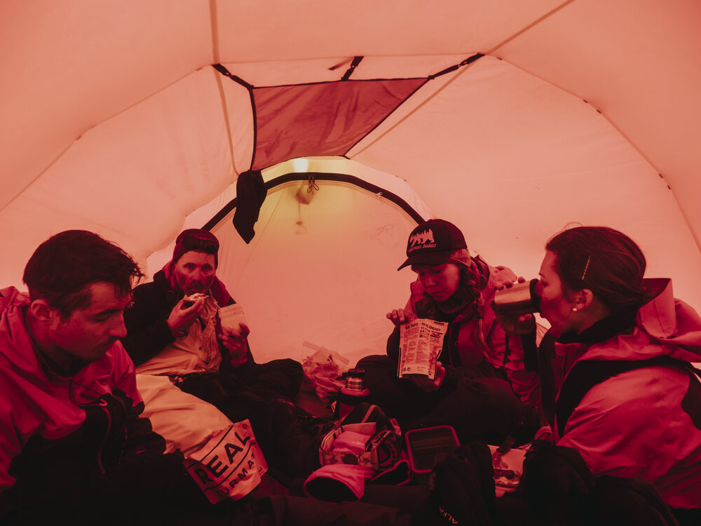 Inspiring Explorers Expedition&trade; team eating in a tent