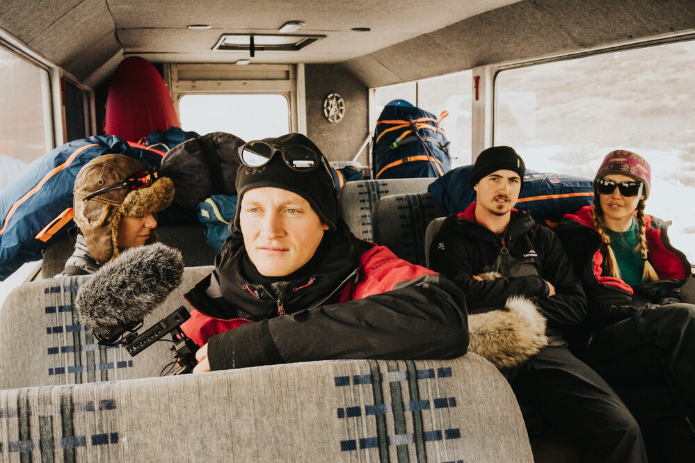 Inspiring Explorers in bus with gear before starting the crossing