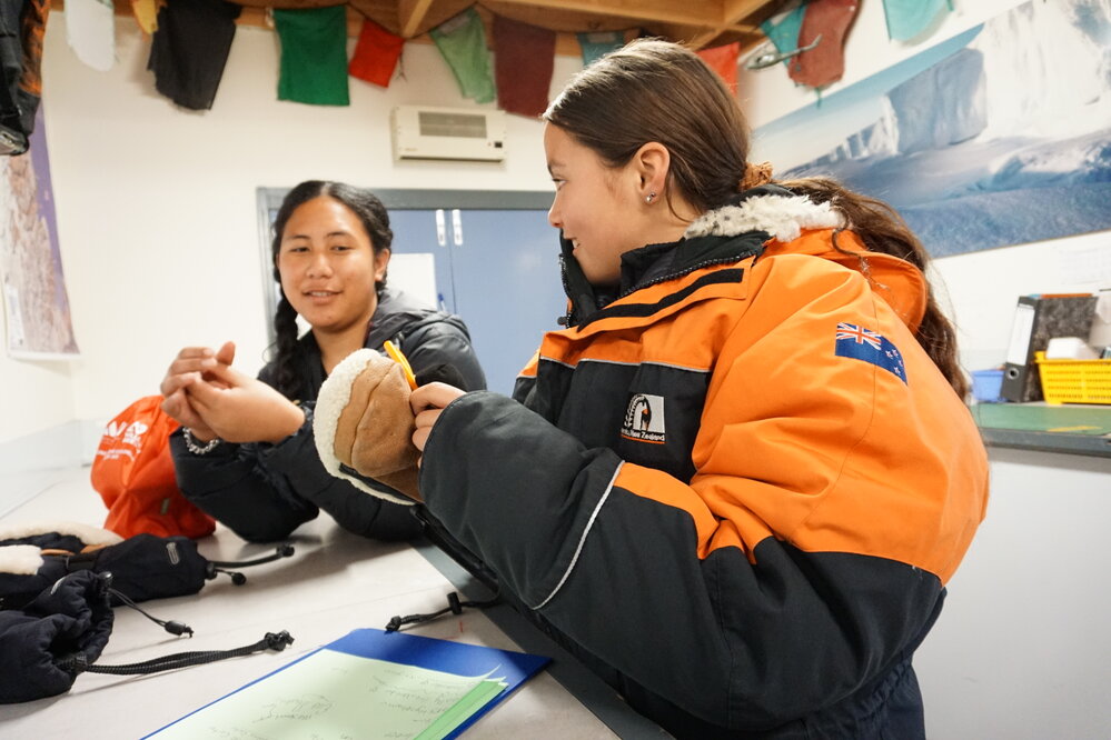 Young Inspiring Explorers Vivian and Kahlen trying on gear at Antarctica New Zealand