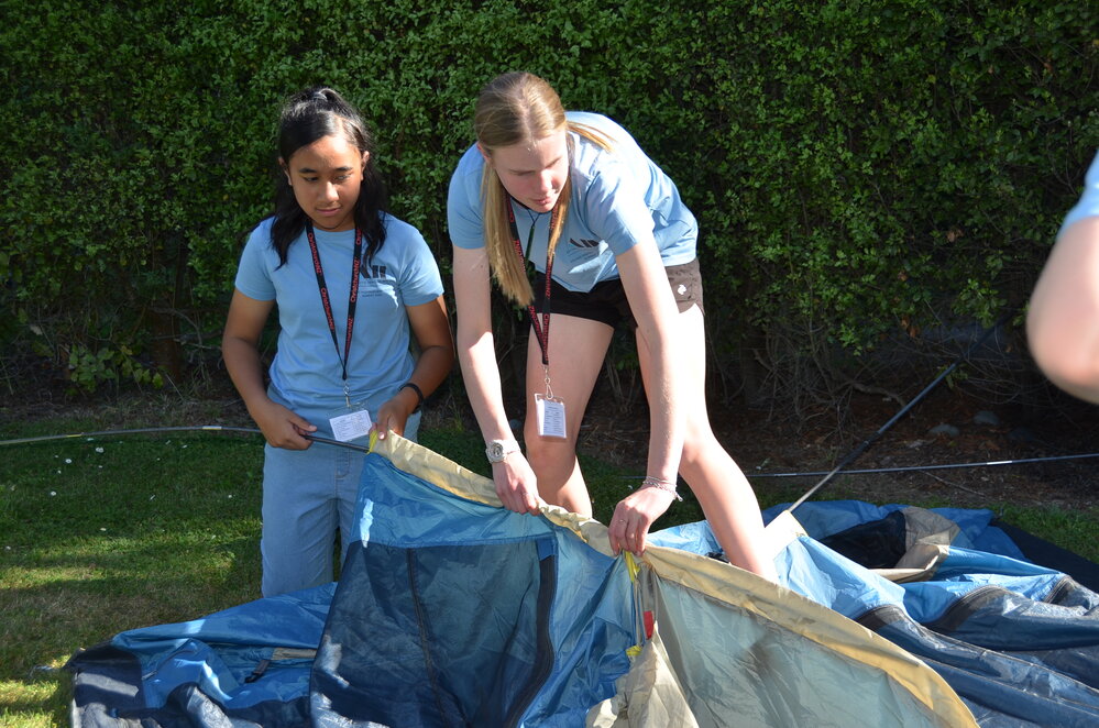 Young Inspiring Explorers&trade; Amy and Audrey help pitch a tent they will sleep in as part of their Antarctic experience