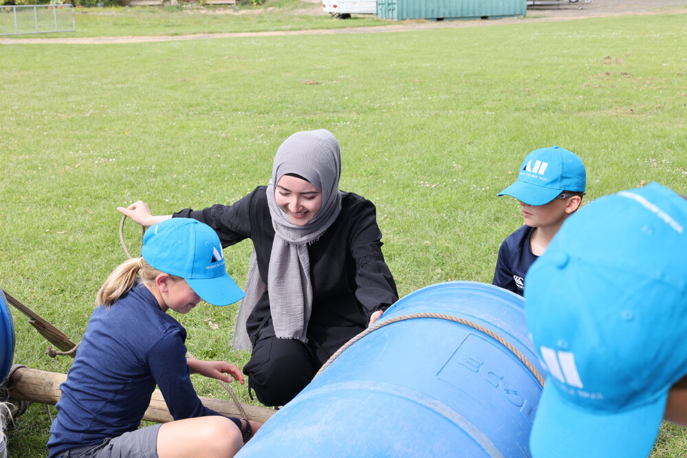 Inspiring Explorer Sadra Sultani assisting students with raft building