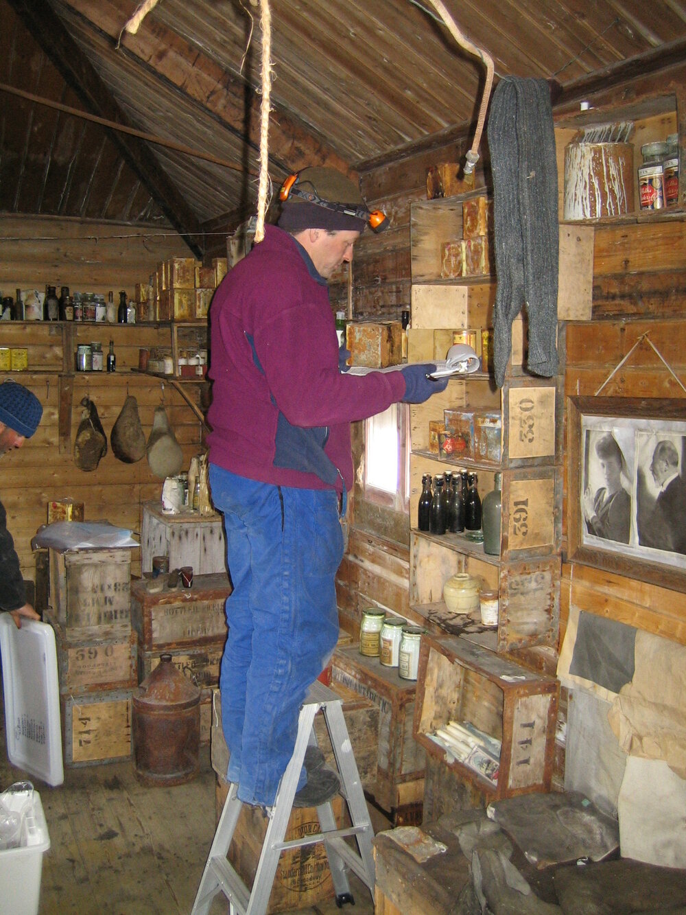 2005 Doug Rogan inventorying artefacts inside Shackleton's 'Nimrod' hut