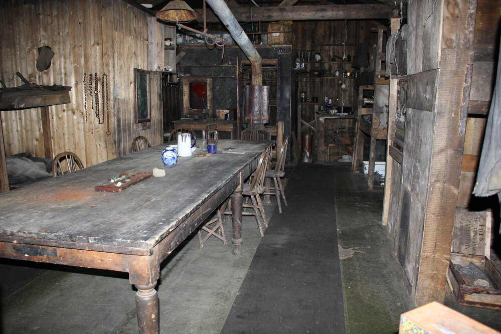 2019-20 Hut inspection - Wardroom table with darkroom beyond, Wardroom (Room 4 Area 8), Scott's Hut