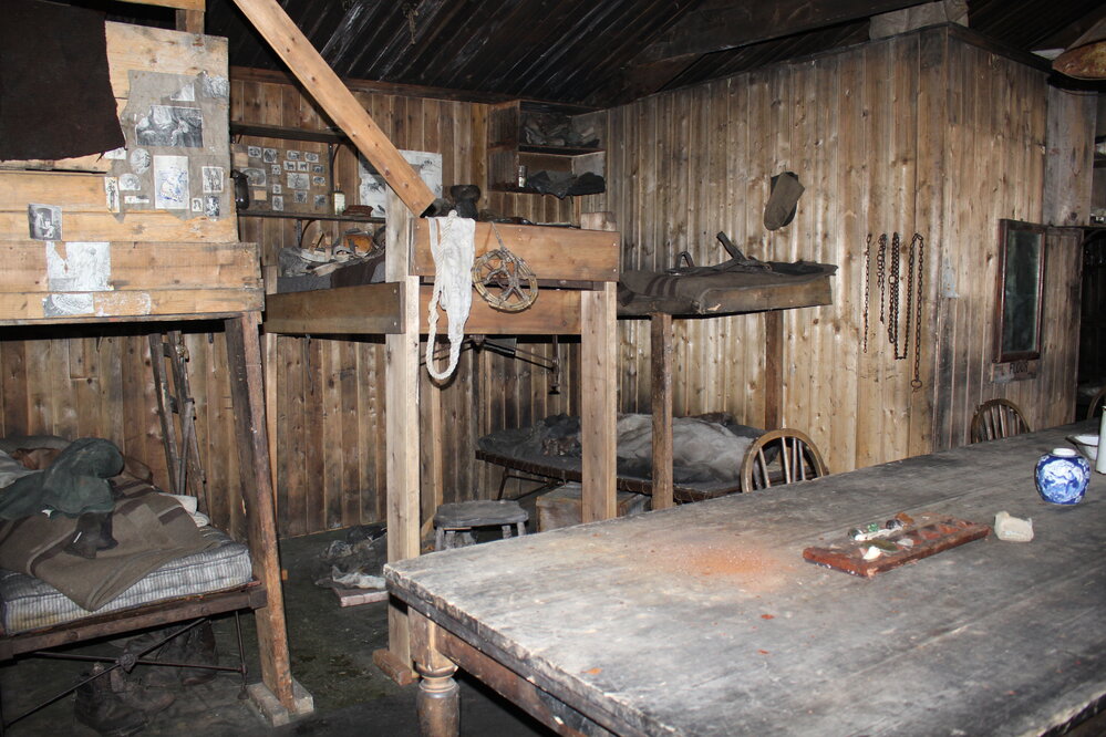 2019-20 Hut inspection - Wardroom table with The Tenements behind, Wardroom (Room 4 Area 8), Scott's Hut
