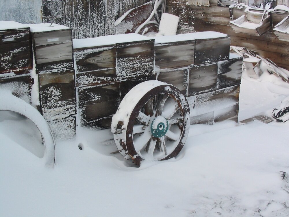 2003 K440 at Shackleton's 'Nimrod' hut, exterior - Arrol-Johnston motor car wheel, in snow