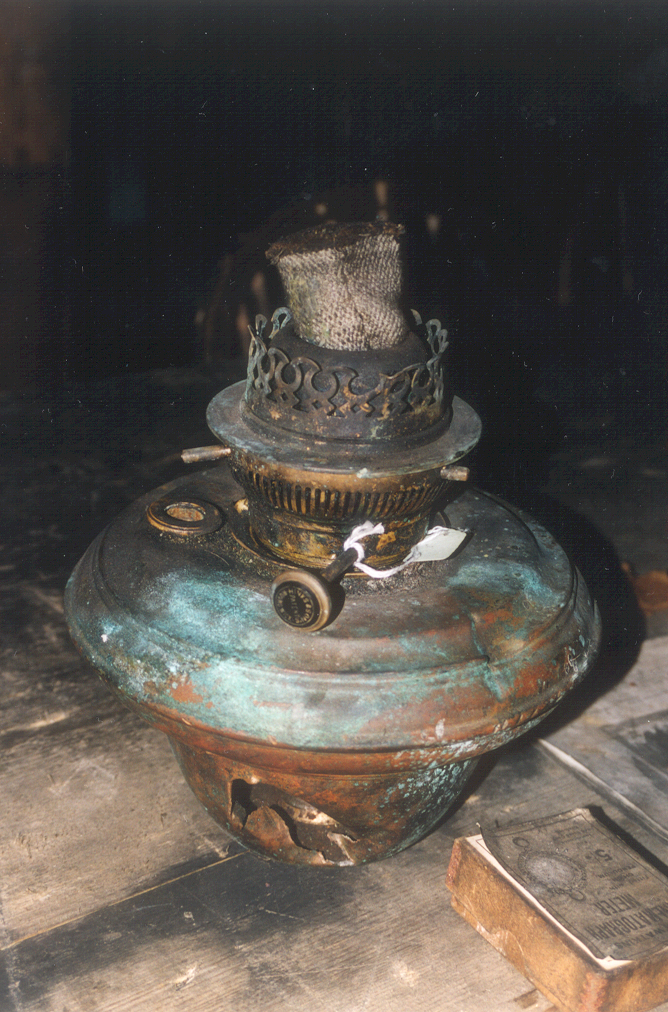 2002 K440B at Scott's 'Terra Nova' hut, interior - Kerosene lamp, Wardroom table