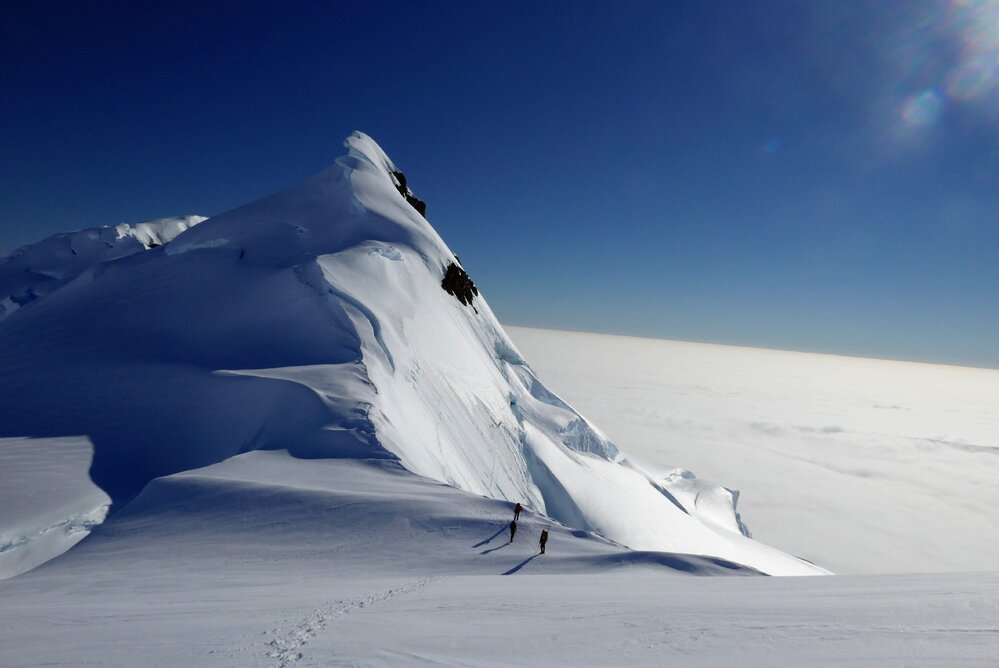 A sea of cloud below Inspiring Explorers Expedition team members