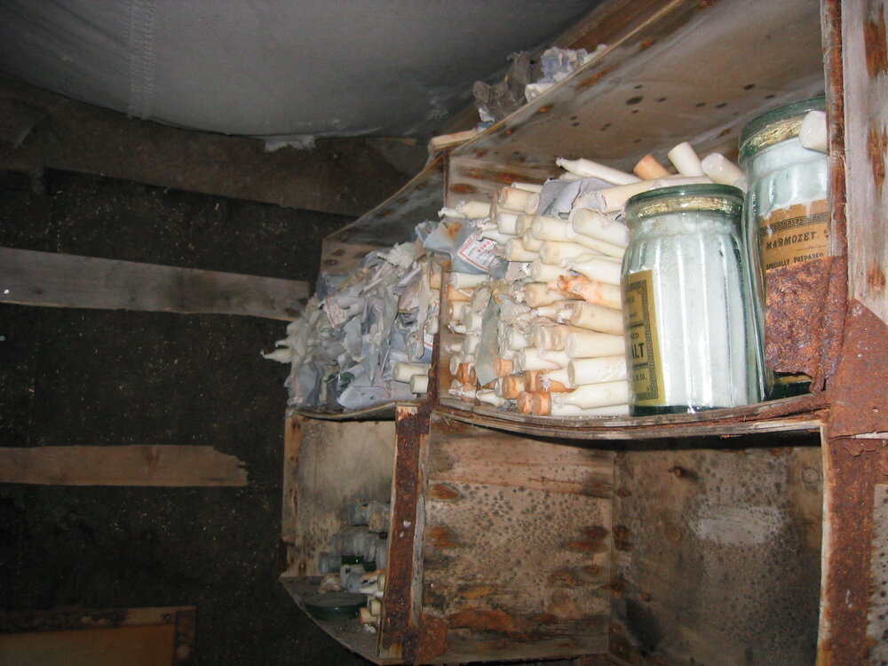 2003-04 Candles stored on Venesta box shelves in darkroom in Shackleton's 'Nimrod' Hut (001)