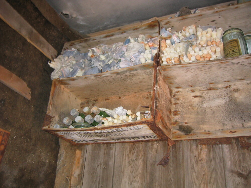 2003-04 Candles stored on Venesta box shelves in darkroom in Shackleton's 'Nimrod' Hut (001)