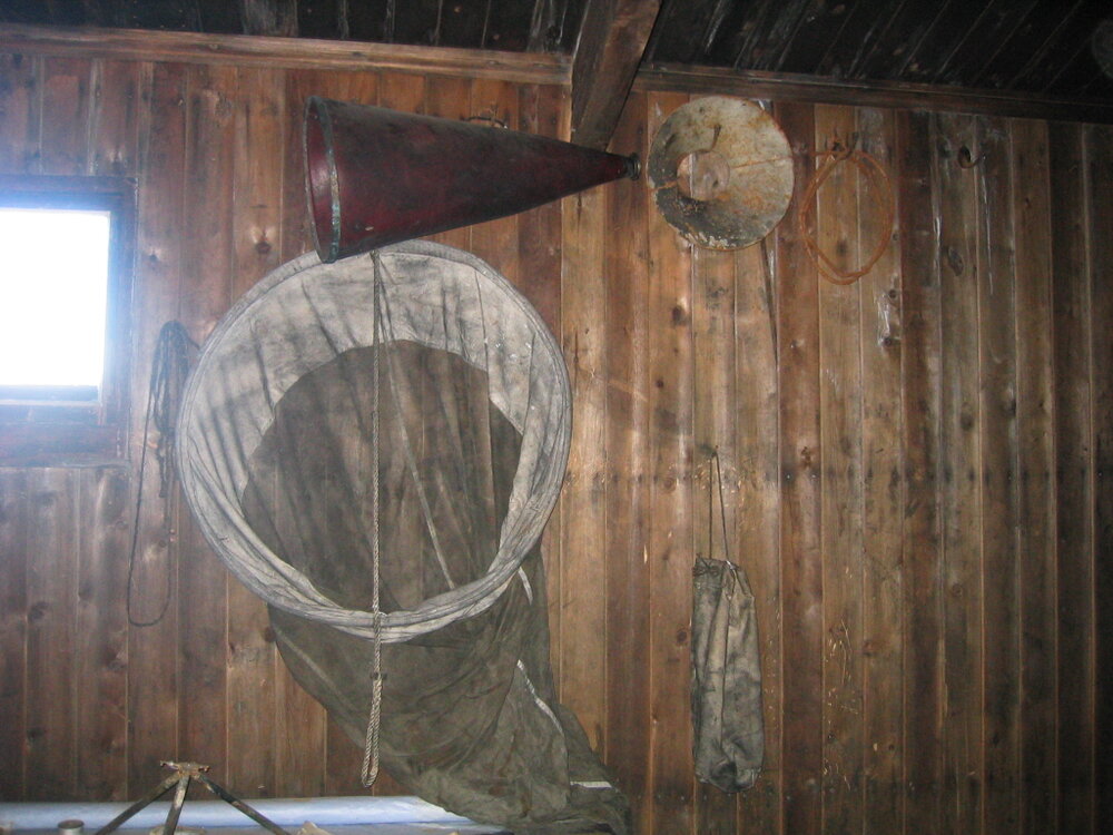 Plankton net and megaphone, north wall above chart table 