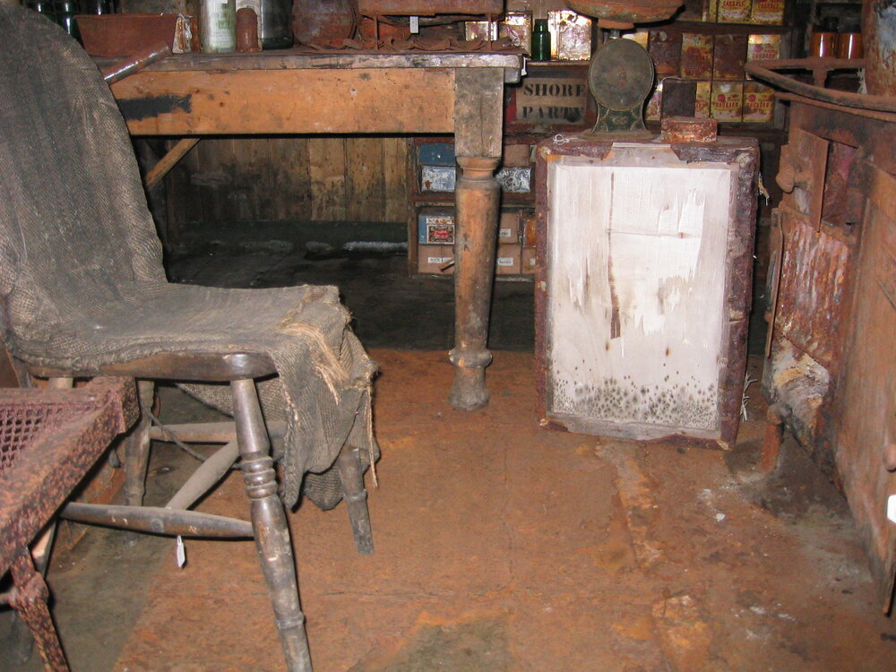 2003-04 Chair (with improvised sacking cover) and table in the galley, Scott's 'Terra Nova' Hut