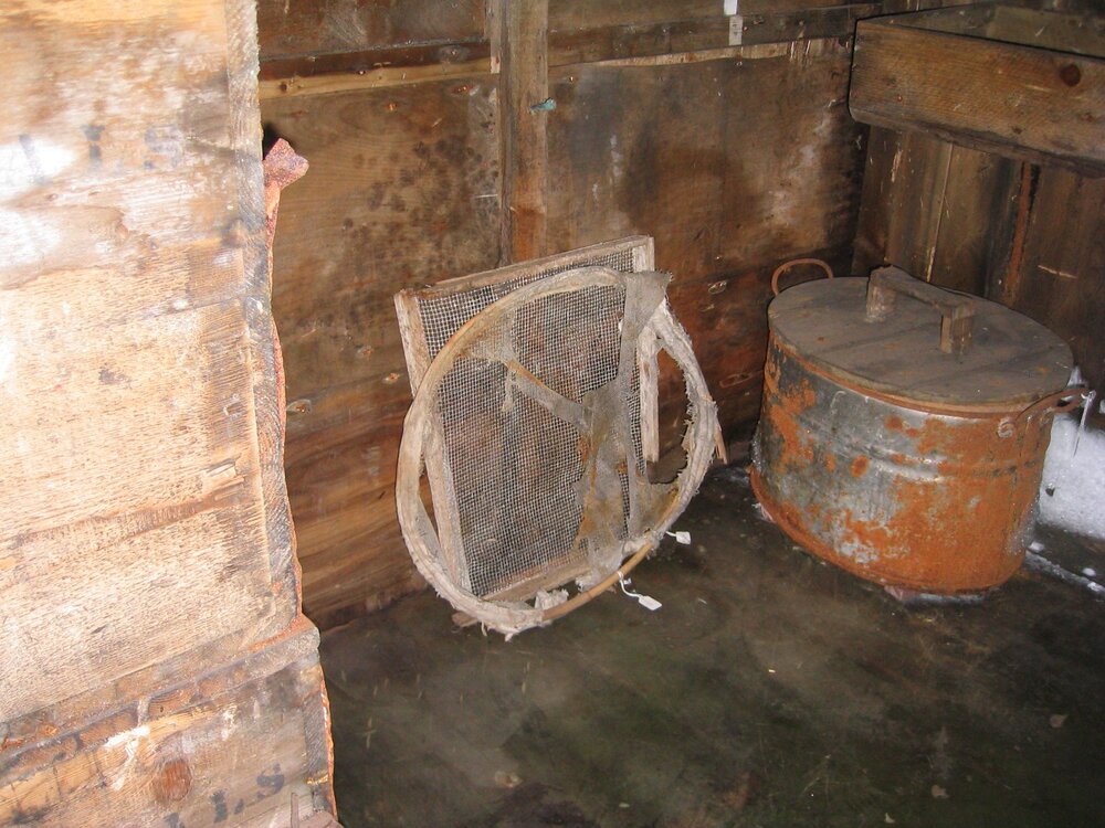 2003-04 Equipment stored beneath biology bench and ice ingress, Scott's 'Terra Nova' Hut
