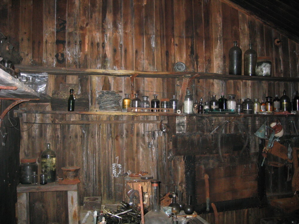 Shelf of chemicals on outside wall of darkroom, Scott's 'Terra Nova' Hut 