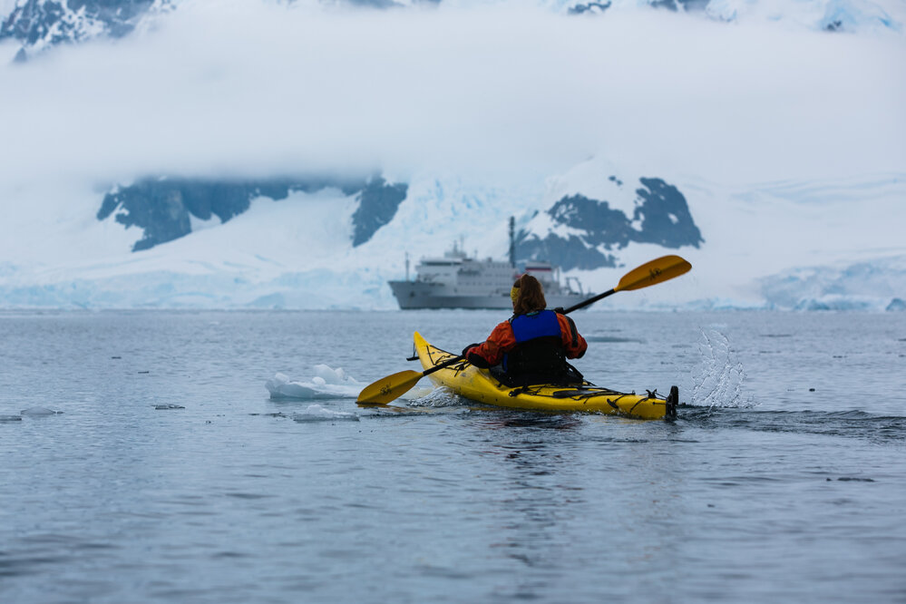 Inspiring Explorer Leah Stewart kayaks with One Ocean 'Navigator' in background