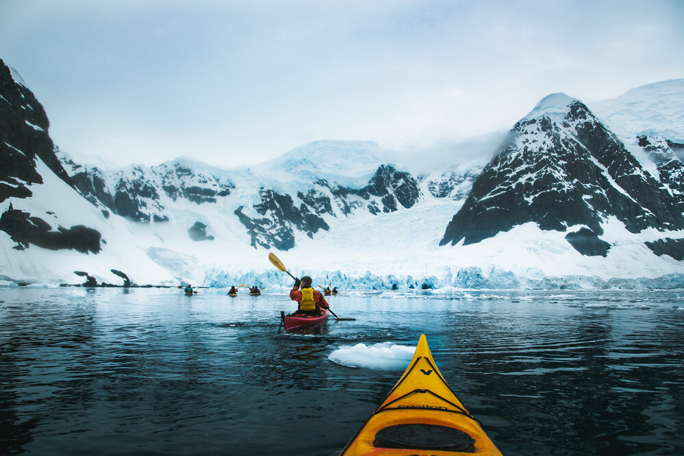 Inspiring Explorers kayak in front of rock mountains and glacial ice (003)