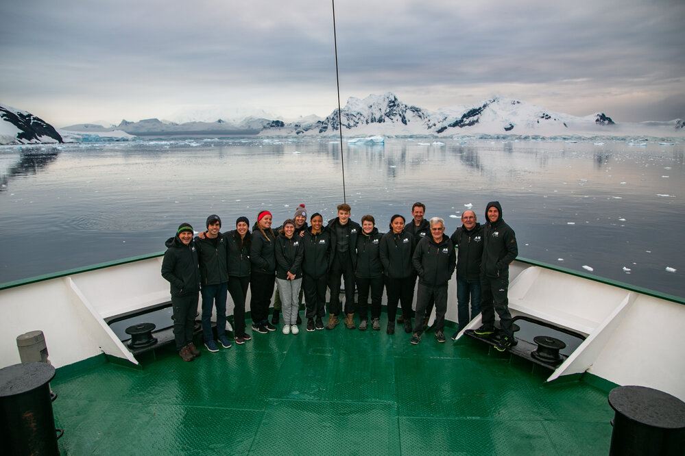 2019 Antarctic Peninsula Expedition team group shot on bow of 'Navigator' 