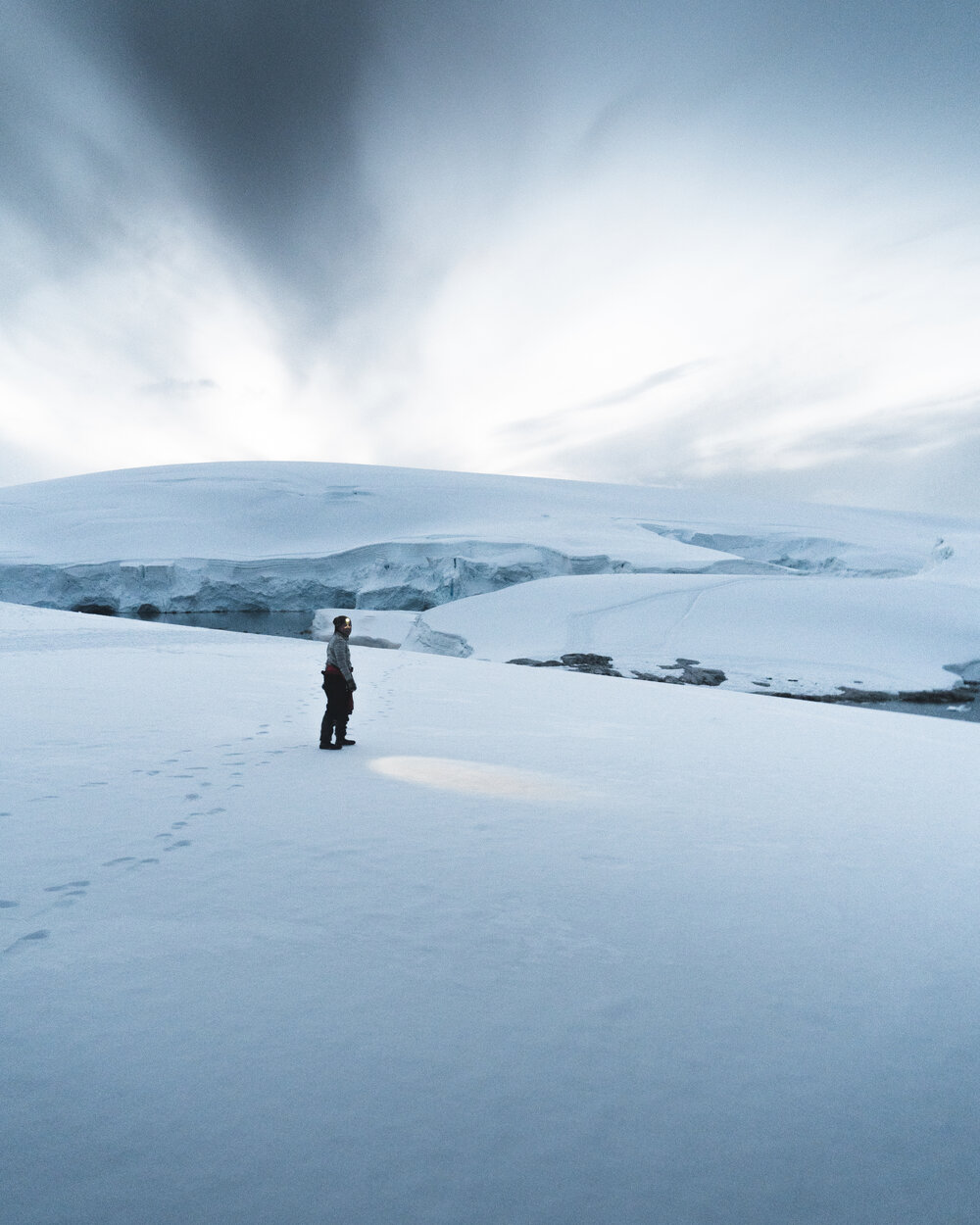 Inspiring Explorer with headlamp on Antarctic Peninsula