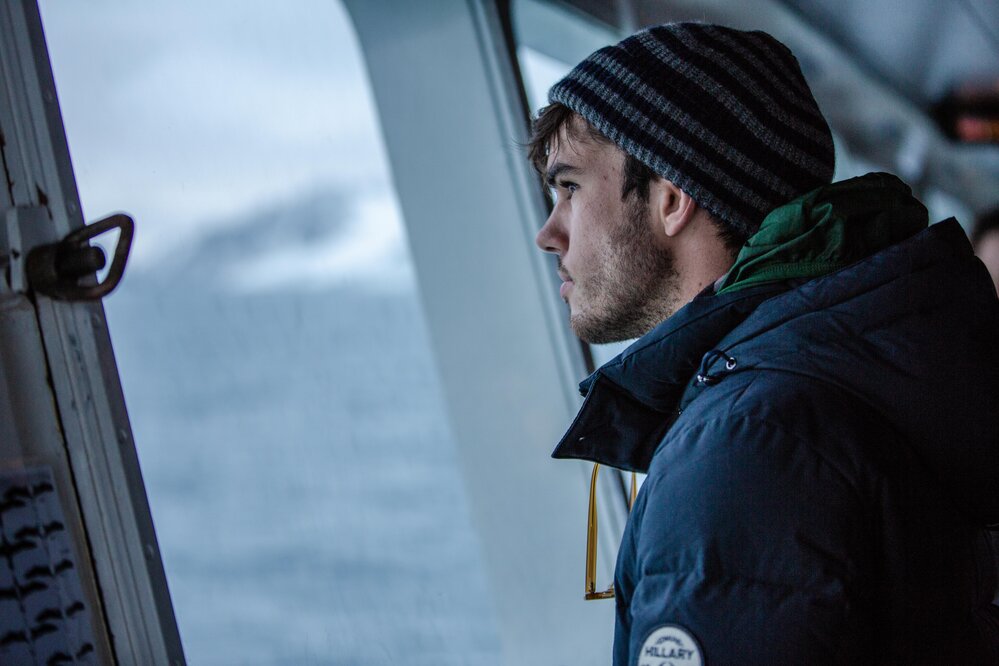 Alexander Hillary gazing out 'Navigator' at Antarctic Peninsula scenery