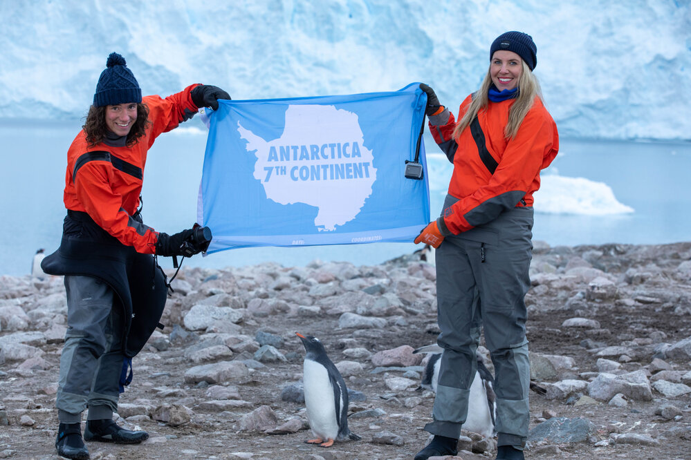 Inspiring Explorers Laurette Siemonek and Anzac Gallate hold up an Antarctic banner