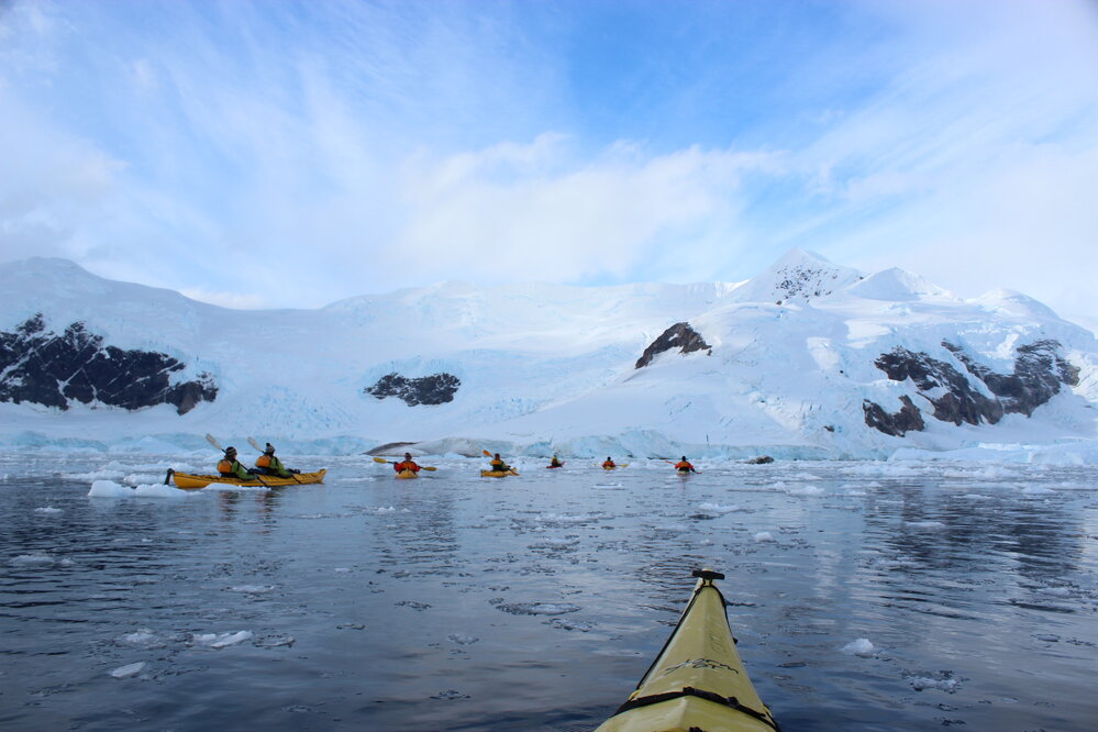 Inspiring Explorers kayaking in a convoy through brash ice