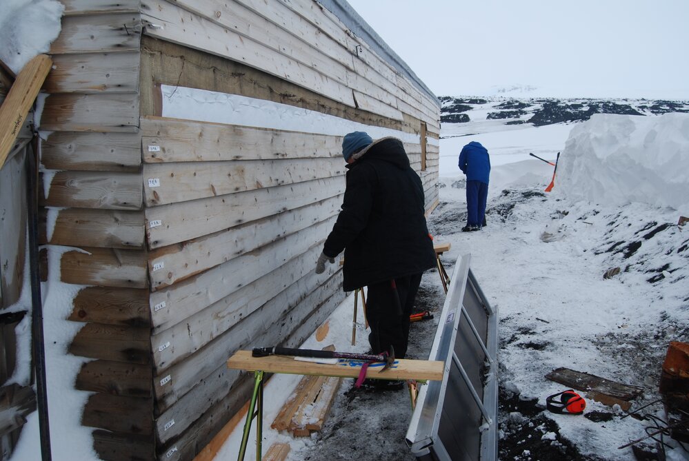 Re-installing cladding, Scott's 'Terra Nova' Hut