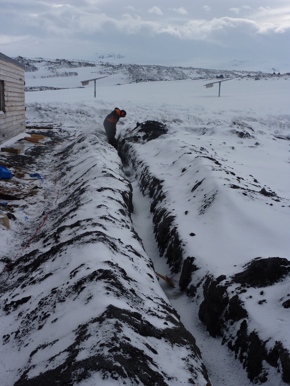 2009-10 AHT's Al Fastier digging trench for deflection dam, Cape Evans