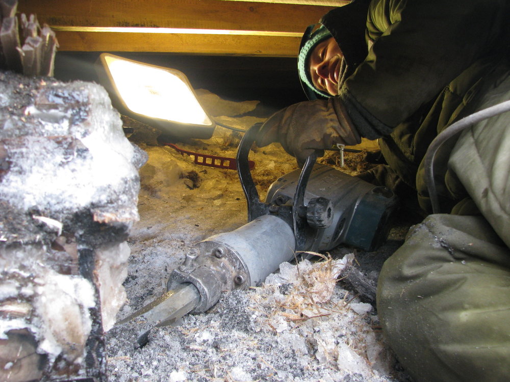 2009-10 AHT Conservator Lucy Skinner excavating alcohol crates underneath Shackleton's 'Nimrod' hut