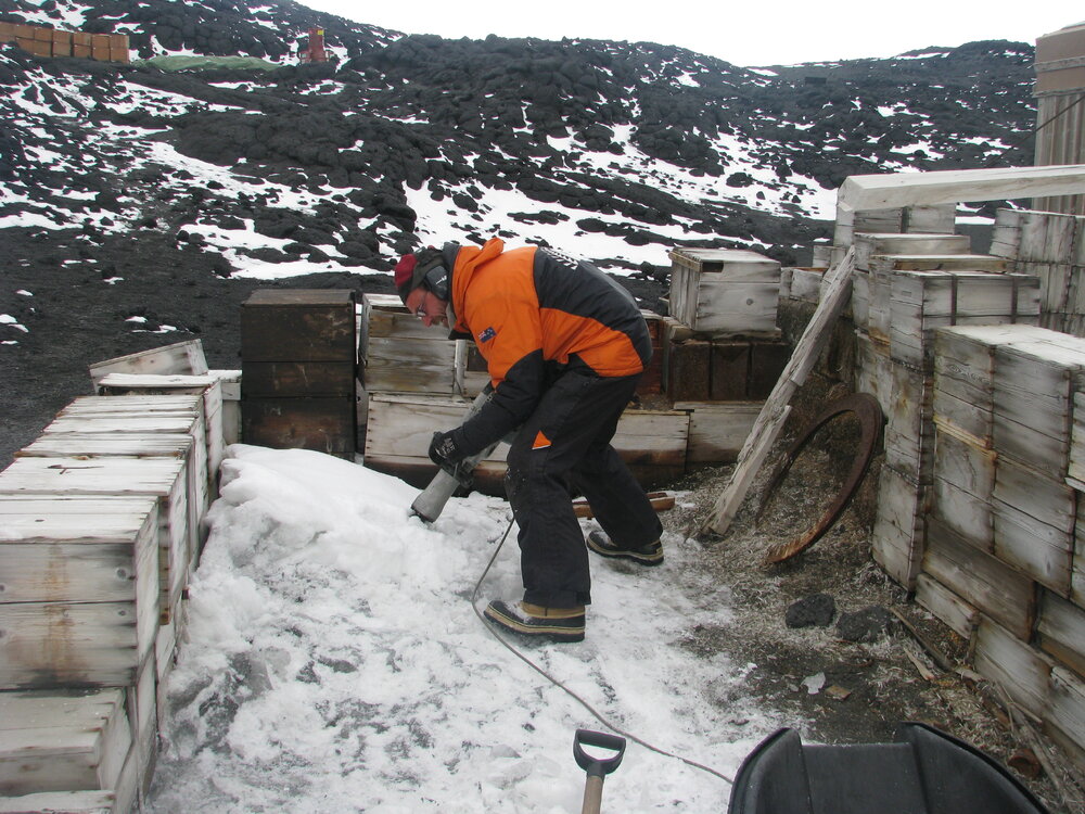 2009-10 AHT's Martin Wenzel removing ice from Garage area, Shackleton's 'Nimrod' hut