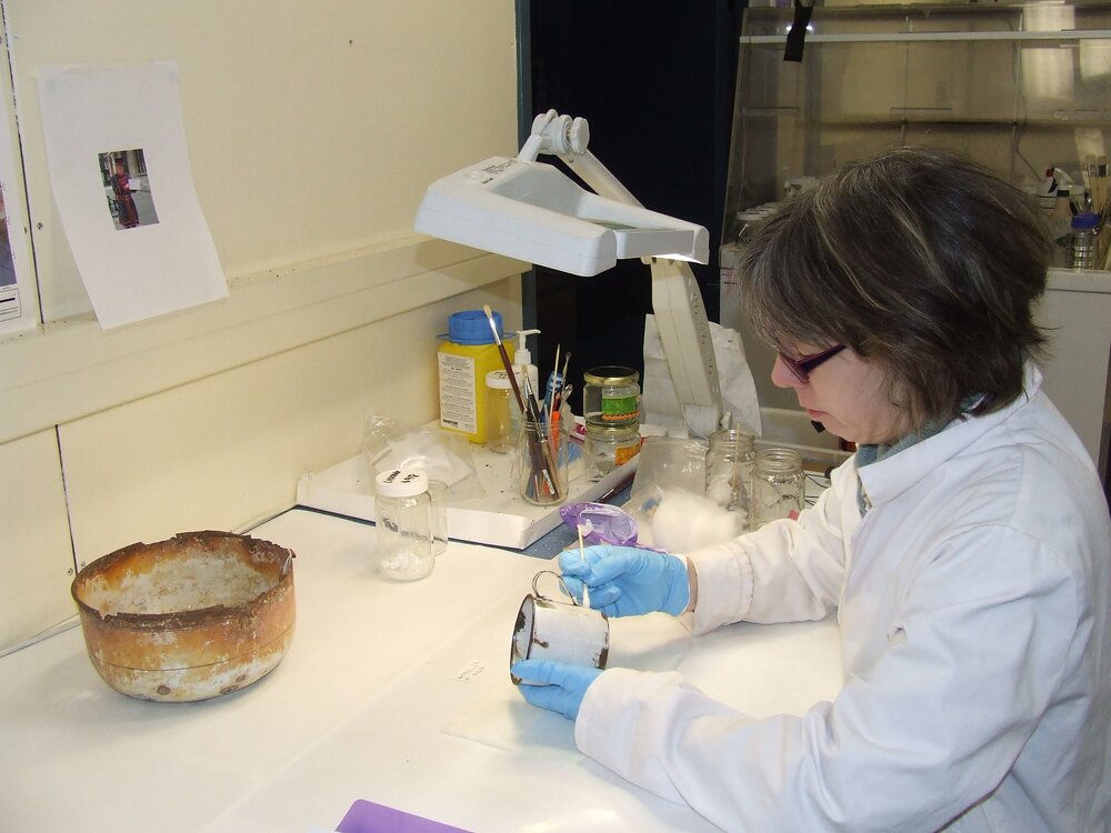 2007 Conservator Fiona Cahill treating an enamel mug