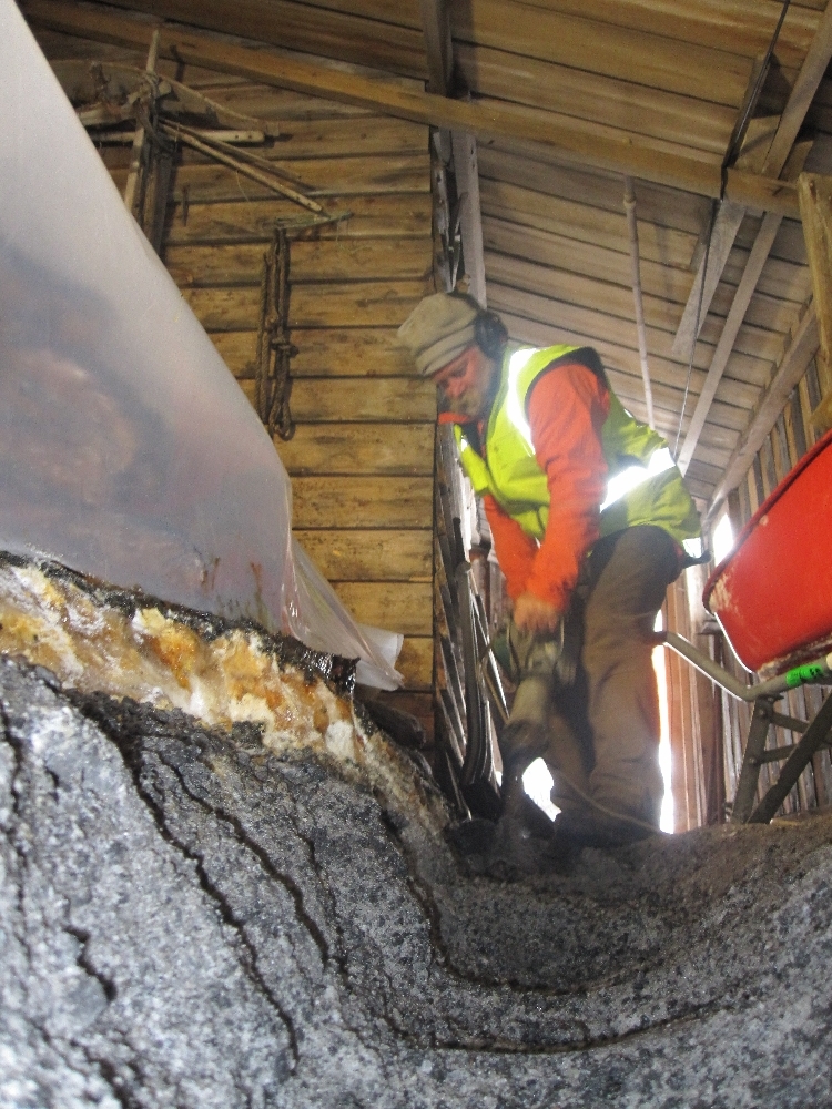2010-11 Al Fastier drilling a trench around the blubber pile, Cape Evans