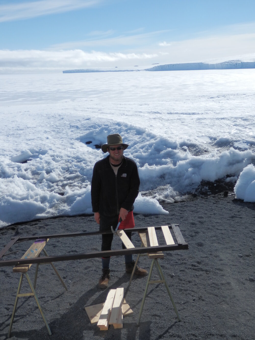 John Evans repairing bed frame, Cape Evans