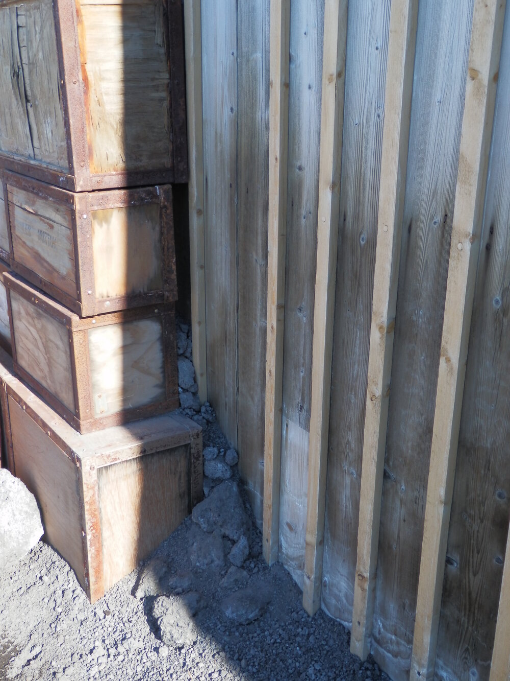 Scoria in-fill behind boxes, Shackleton's 'Nimrod' Hut