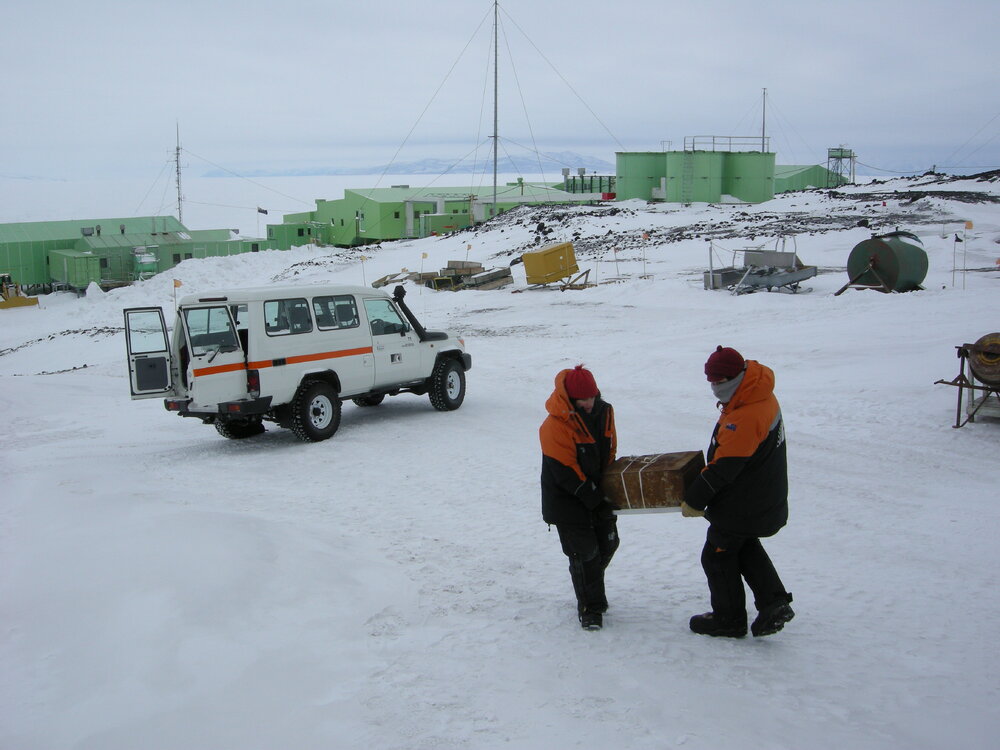 2013-14 Lizzie Meek and Josiah Wagener carry artefacts from a truck, Scott Base (002)