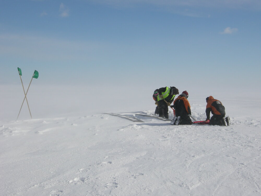 2013-14 AHT staff preparing tracks over a crack in the sea ice