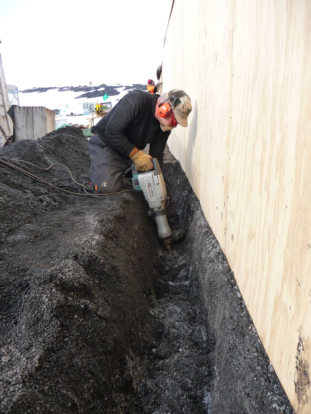2009-10 AHT's Al Fastier digging trench along Stables exterior, Scott's 'Terra Nova' hut