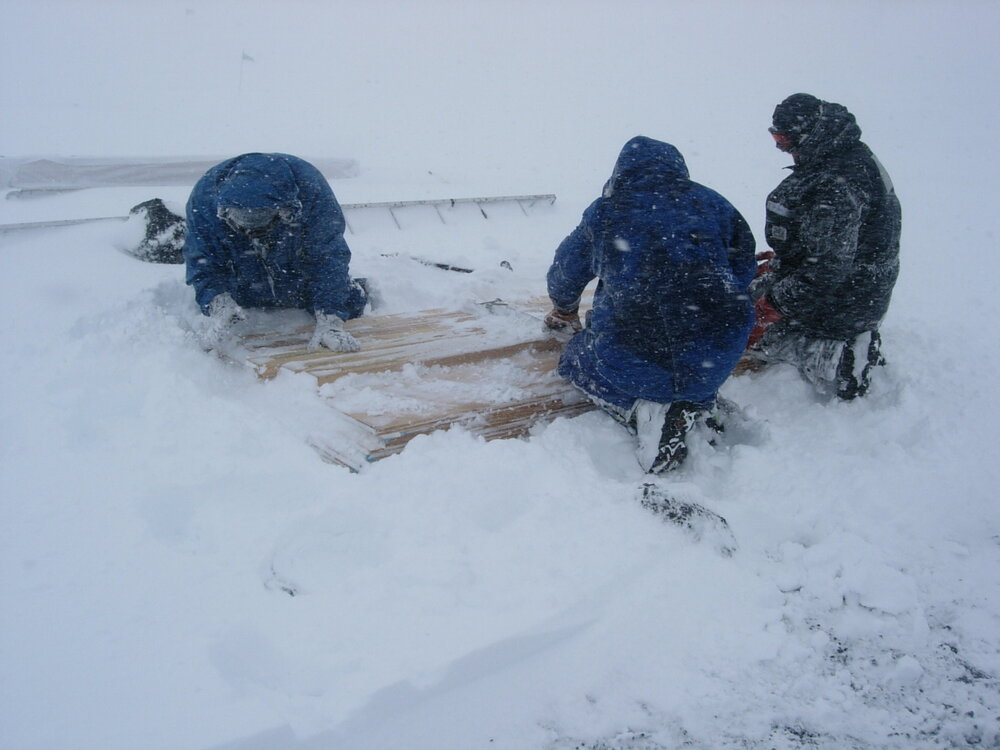 K170 carpentry team working in a snow storm