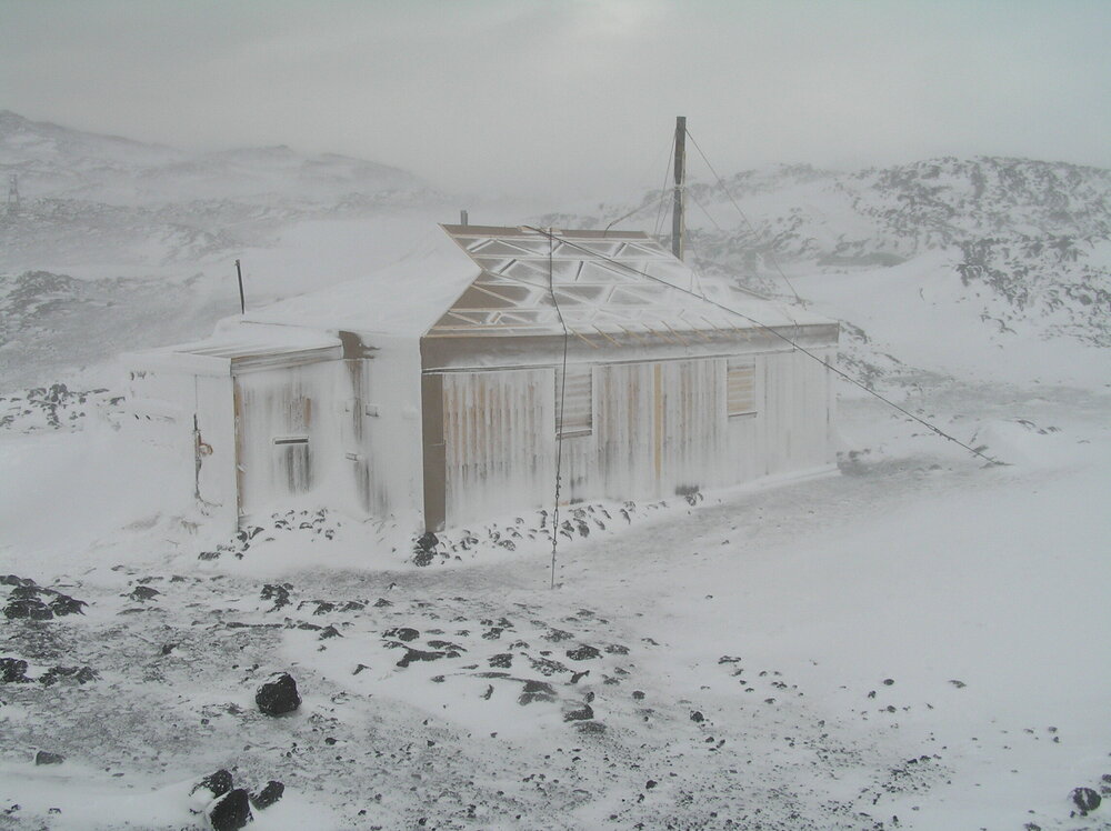 Snow build-up, southwest elevation of Shackleton's 'Nimrod' hut