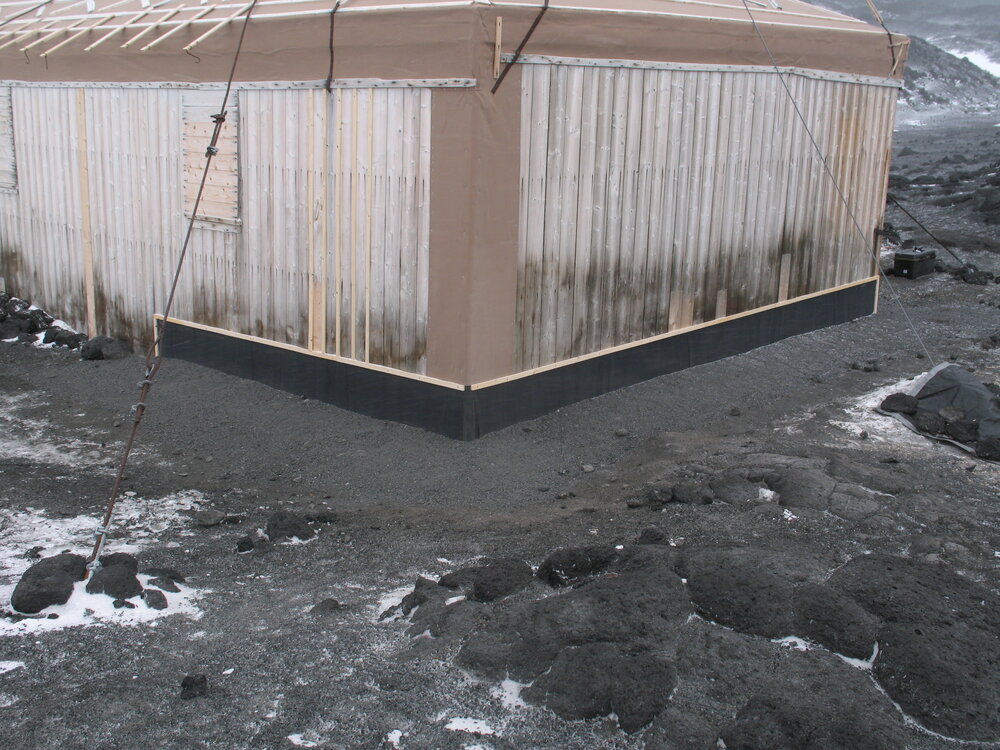 Fixed Butynol valance at base of southeast corner, Shackleton's 'Nimrod' hut