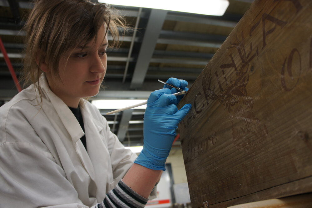 2012 AHT's Georgina Whiteley treating whisky crate, Scott Base