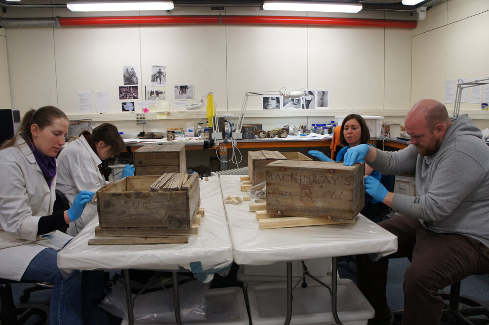 2012 AHT conservators treating excavated alcohol crates, Scott Base
