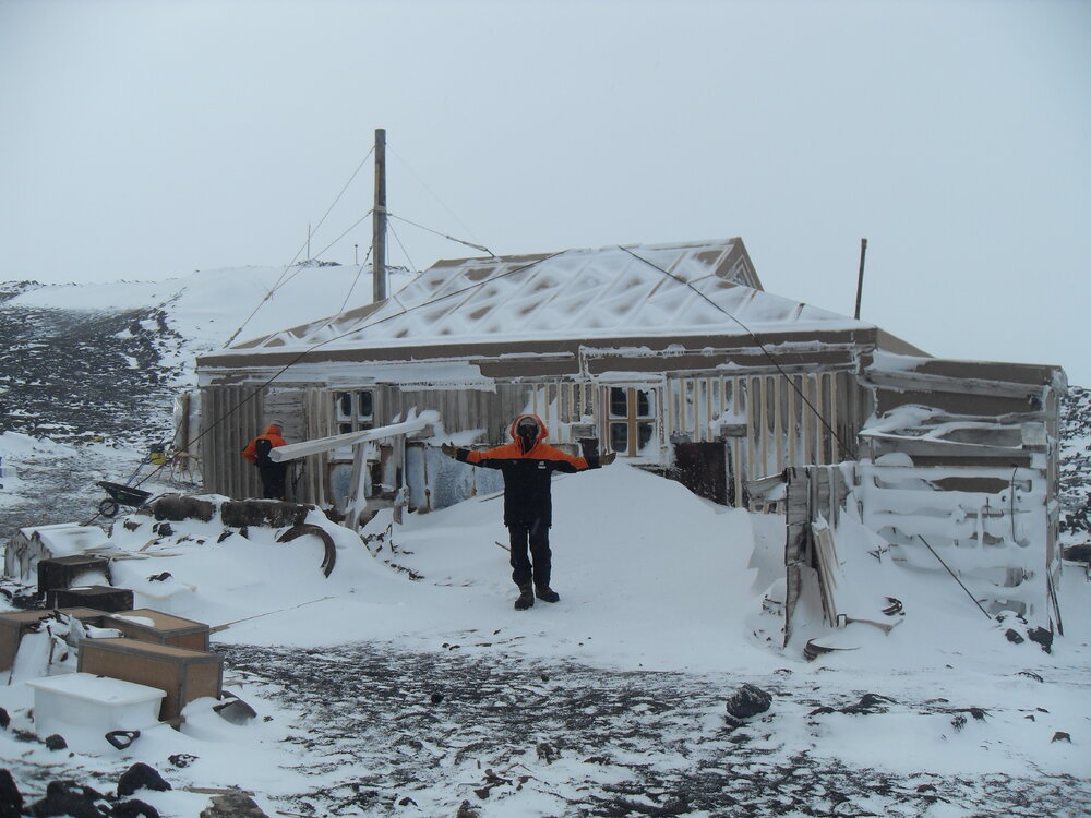 2010-11 Jamie Clarke outside Shackleton's 'Nimrod' hut, Cape Royds