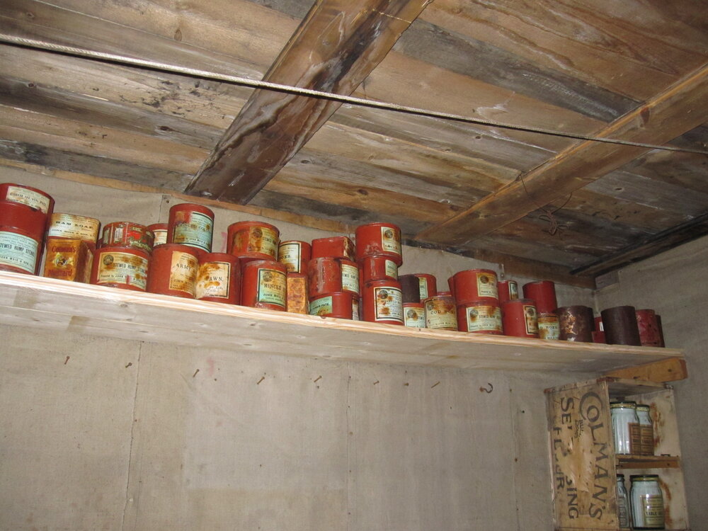 2010-11 Tinned provisions on a shelf inside Shackleton's 'Nimrod' hut