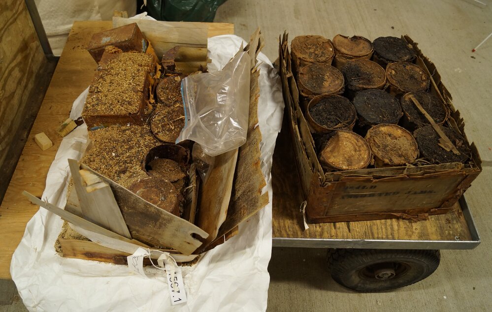 Boxes of food tins before treatment