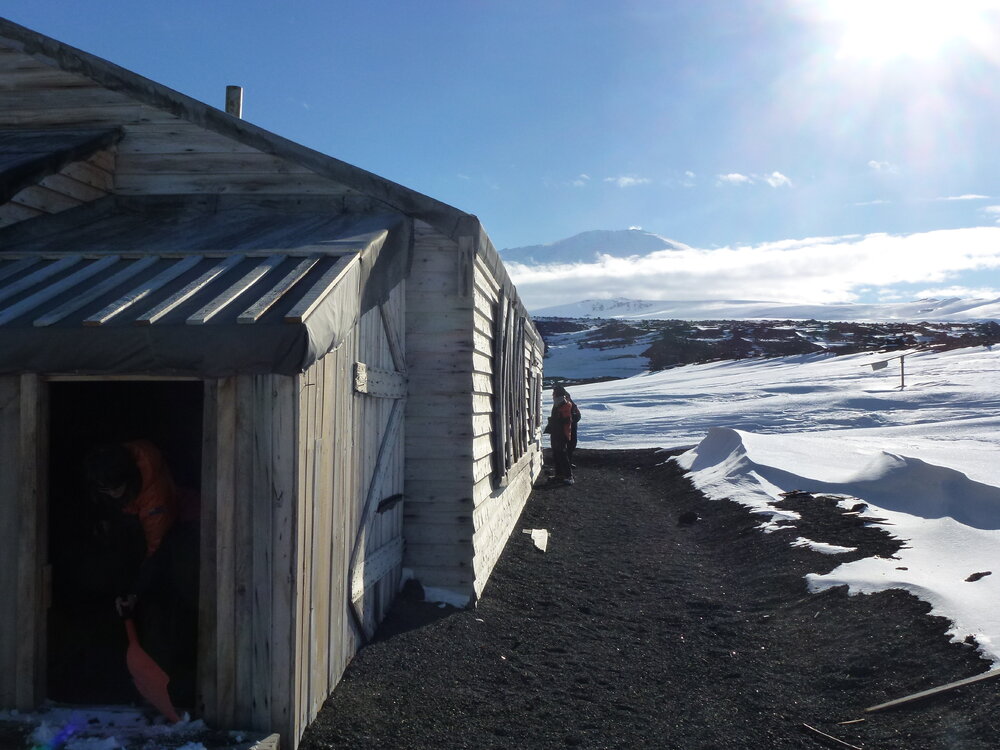 Inspecting exterior, Scott's 'Terra Nova' hut