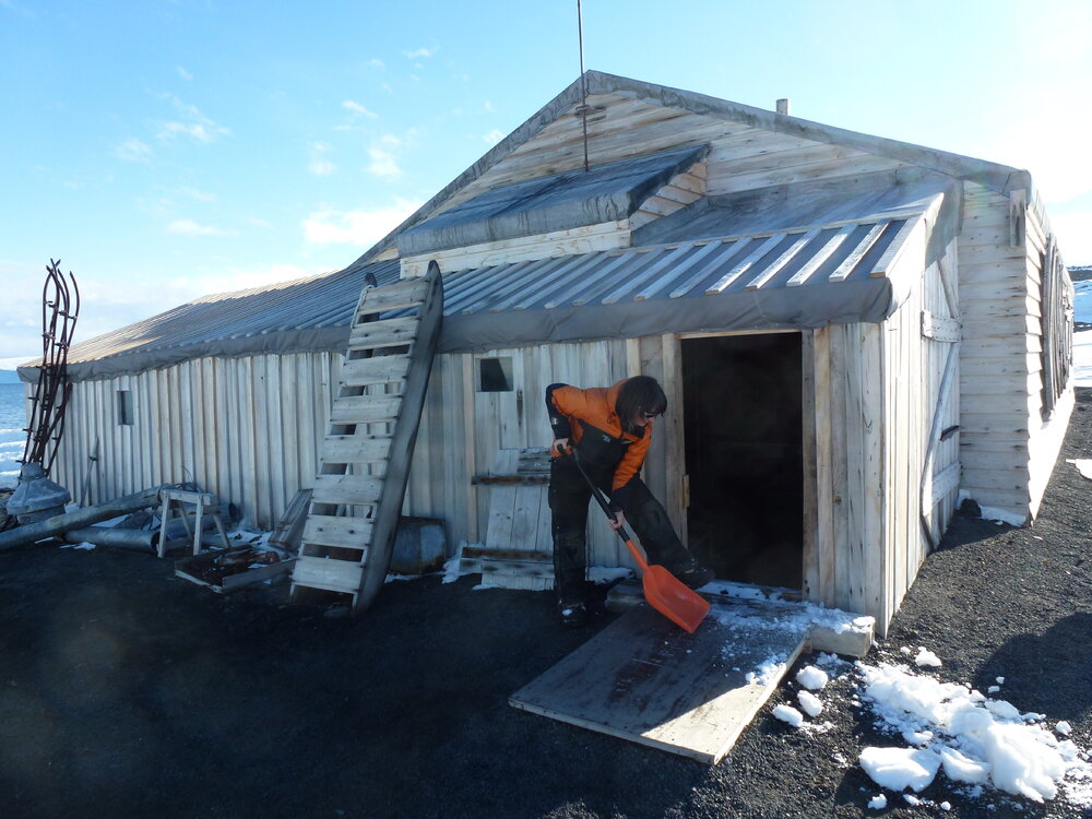 Removing snow from entrance, Scott's 'Terra Nova' hut 