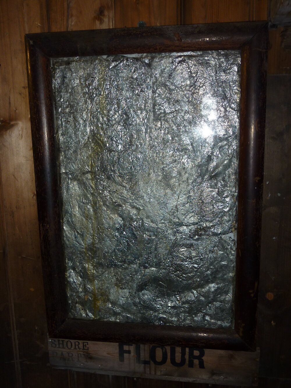 2010-11 Improvised foil mirror mounted on the Wardroom wall, Cape Evans