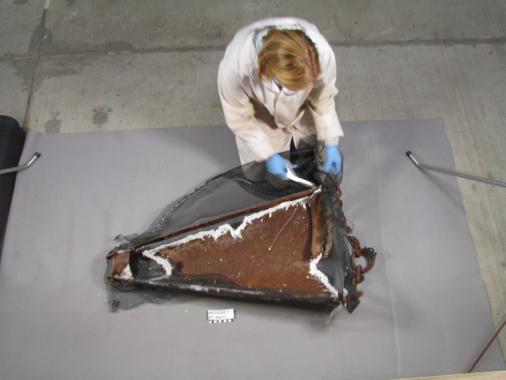 AHT Conservator Julie Unruh cutting away working on dredge (001)
