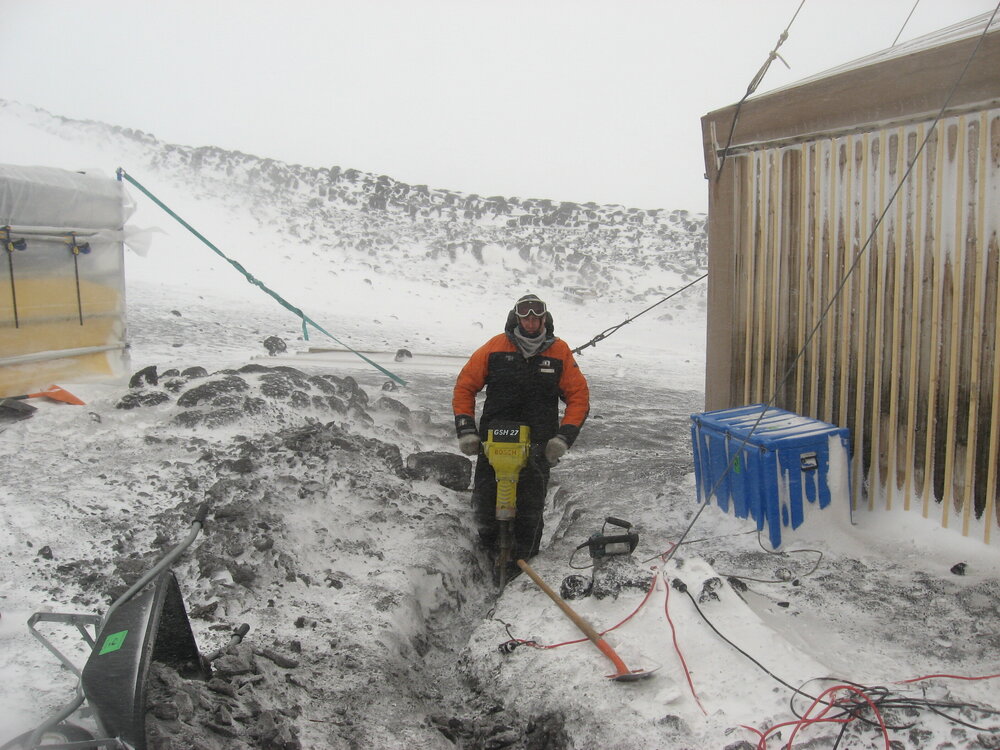 2010-11 John Taylor digging a trench outside Shackleton's 'Nimrod' hut