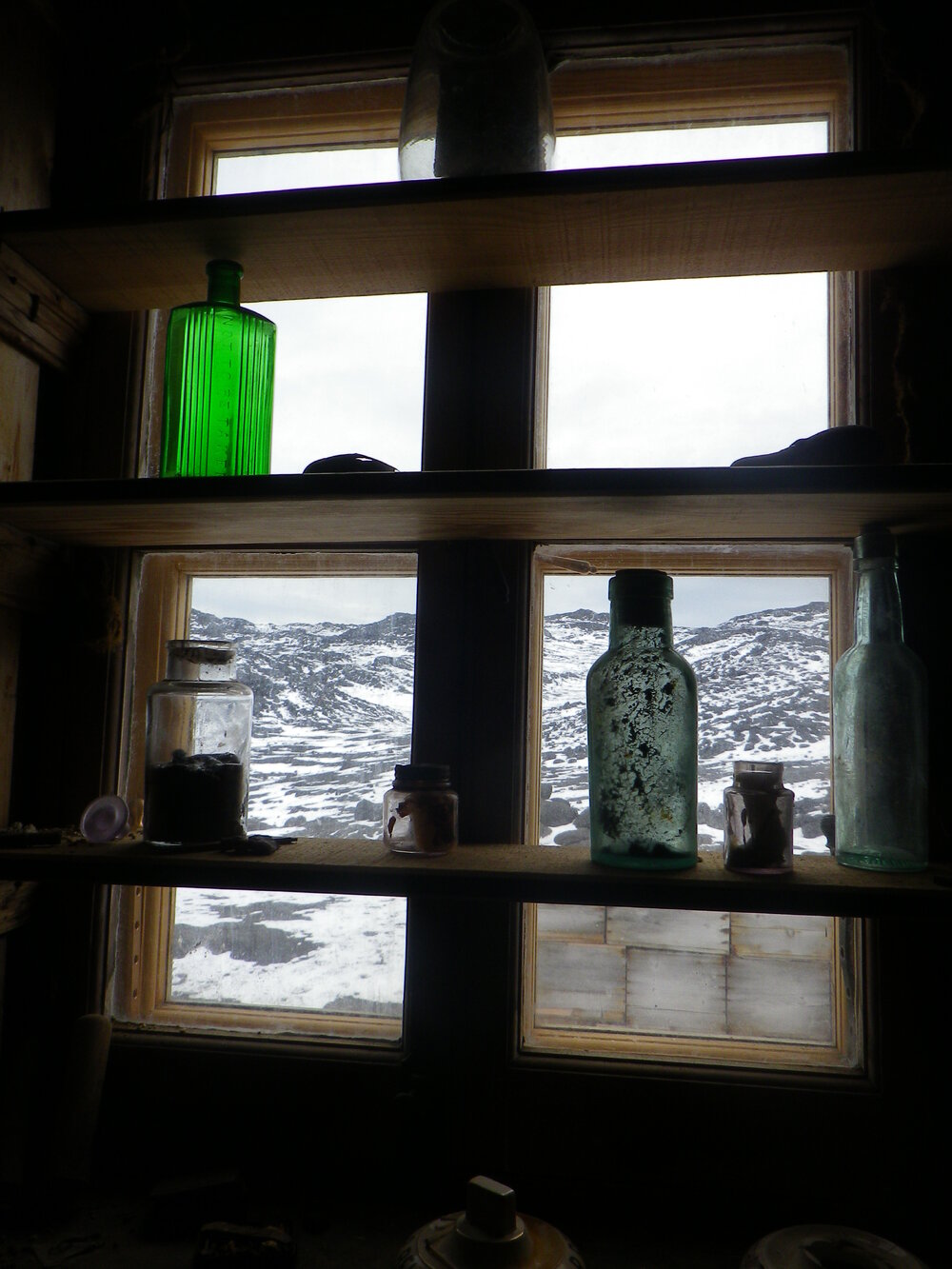 2014 Shackleton's 'Nimrod' hut interior, glass bottles at North facing window